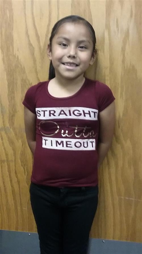 A female student posing for a picture as the spotlight student of the month. 